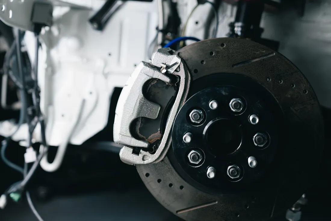 Brake service — close-up of a car brake caliper and disc rotor