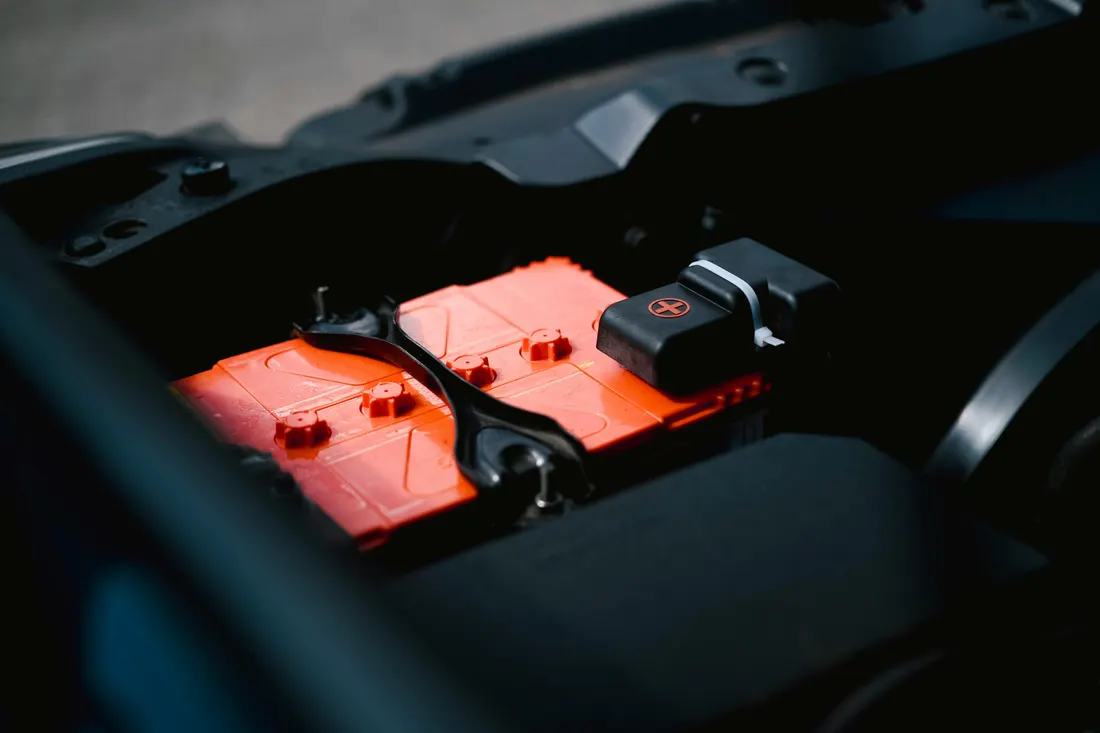 Starter replacement — close-up of a car battery in the engine bay